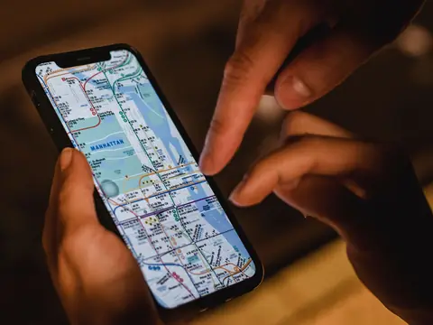 Hands holding a phone open on a city map