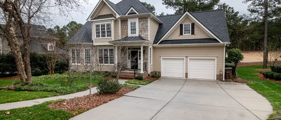 A two-story house with a double garage and a wide driveway